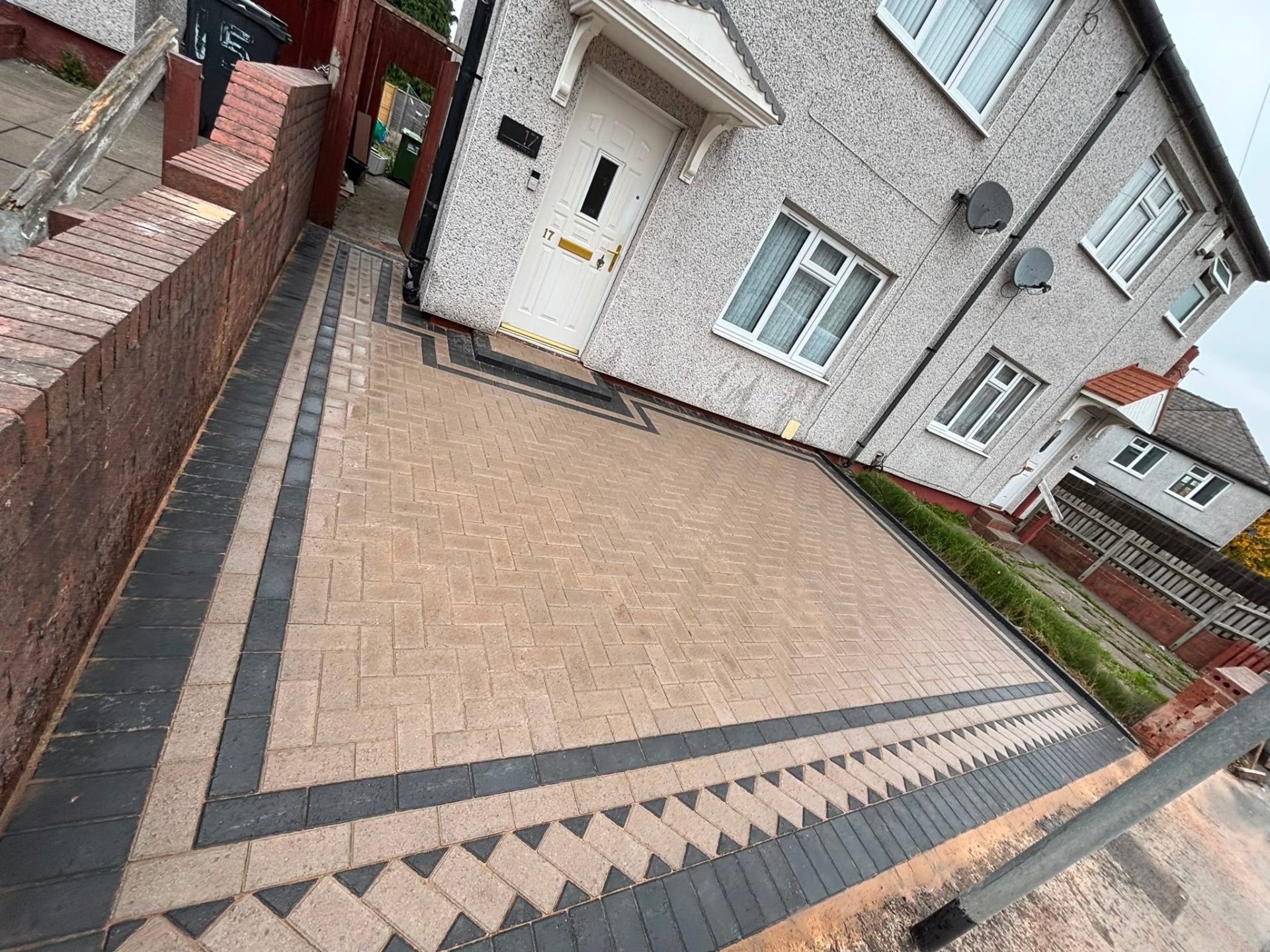 Buff tan block paving driveway with dark charcoal border and diamond inset feature