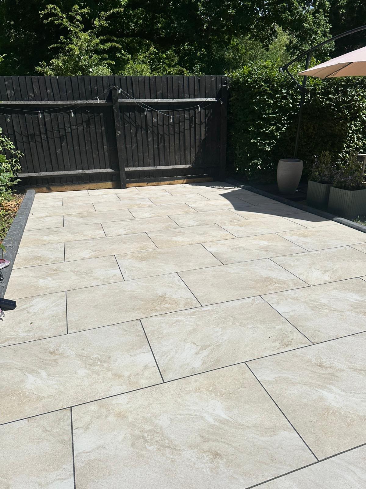 Beige stone-effect porcelain patio laid in stack bond pattern — Built 2 Last install